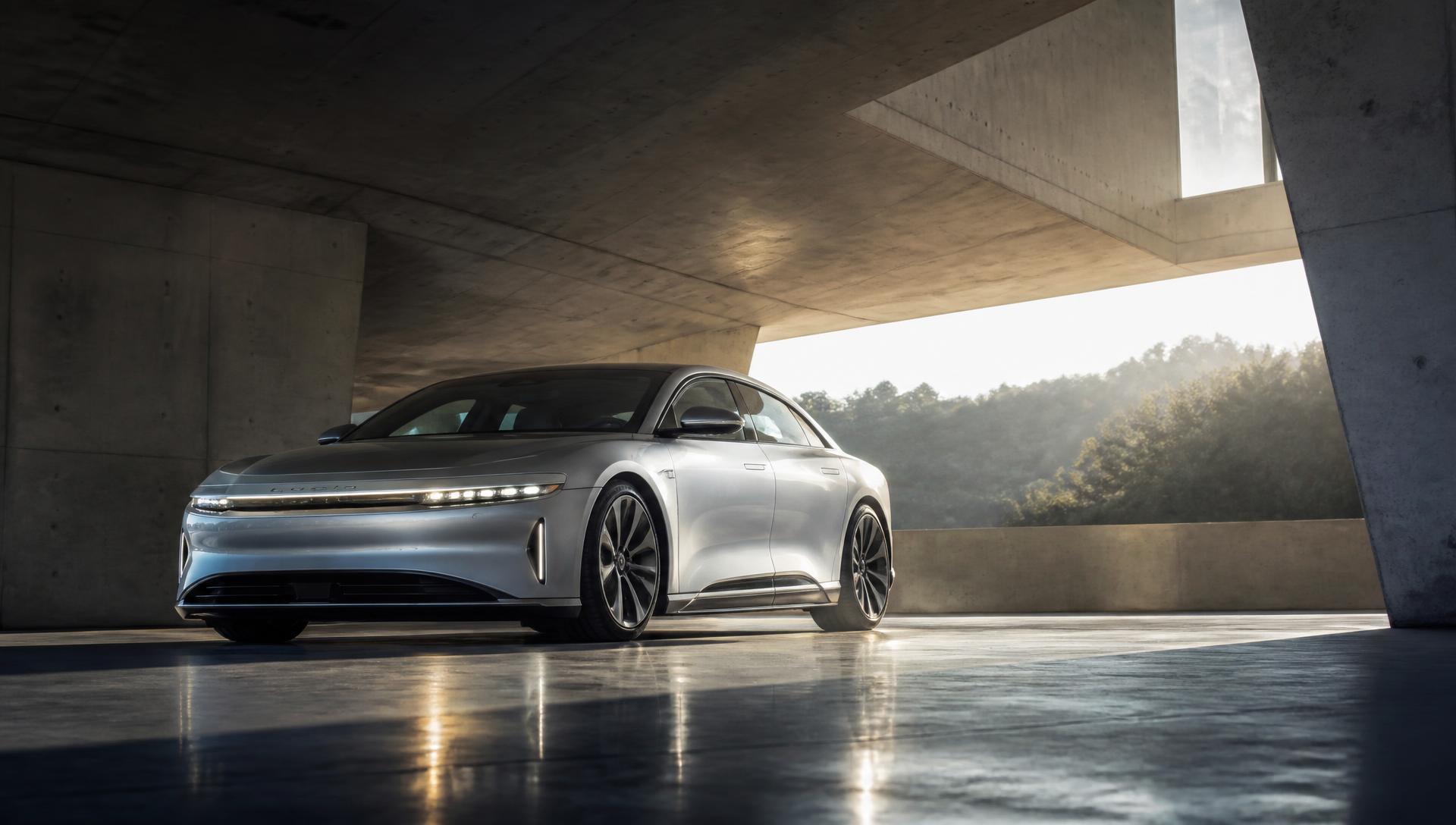 Silver luxury sedan in a brutalist concrete pavilion